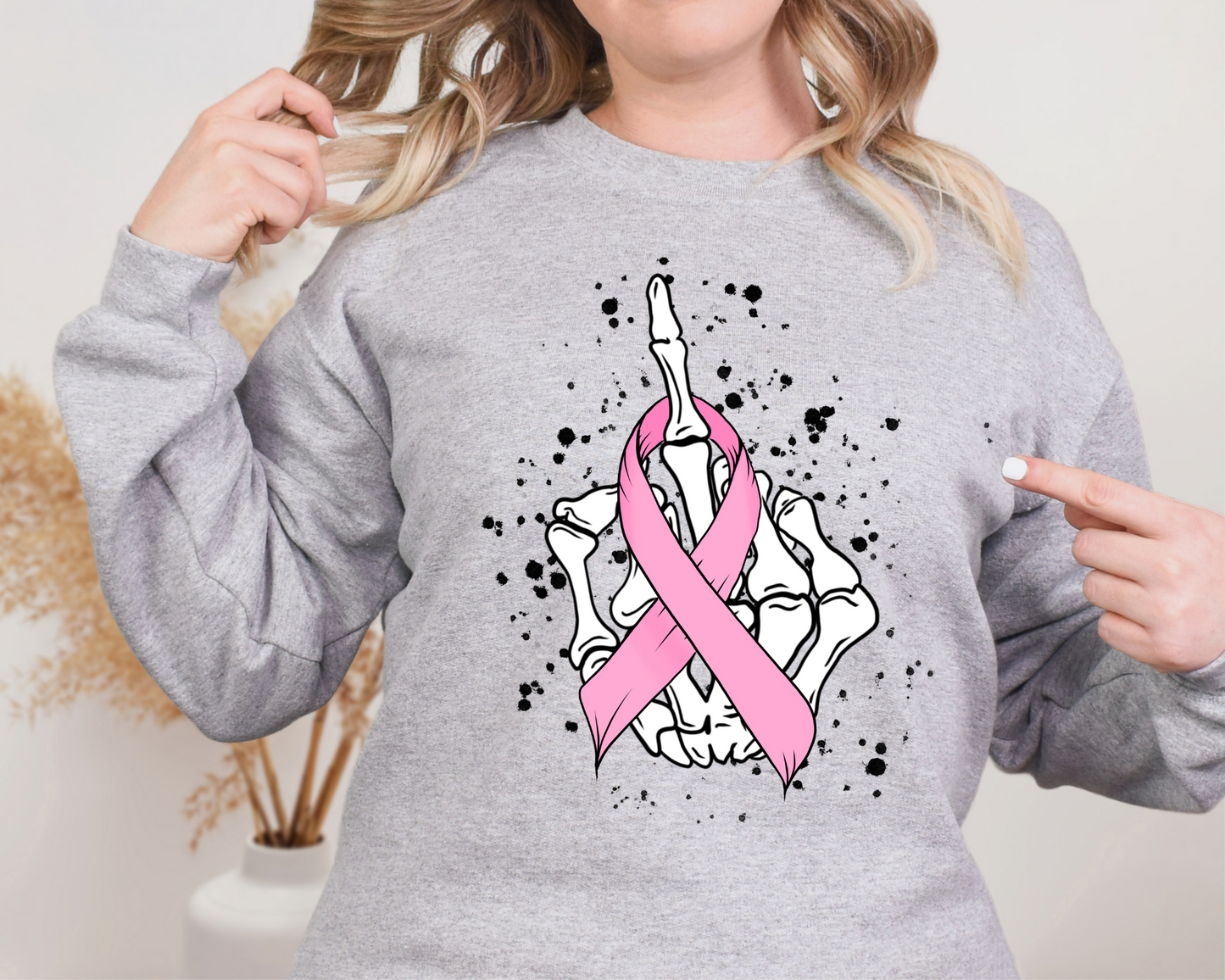 Pink ribbon wrapped on skeleton middle finger